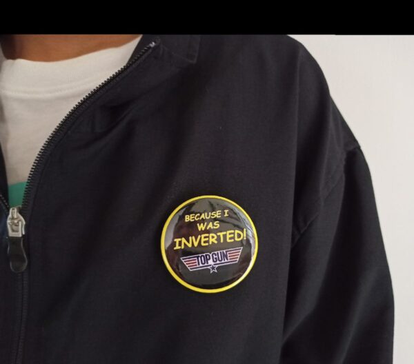 Image of Pin Badge Top Gun Quote 'Because I was Inverted' Black Yellow on Jacket