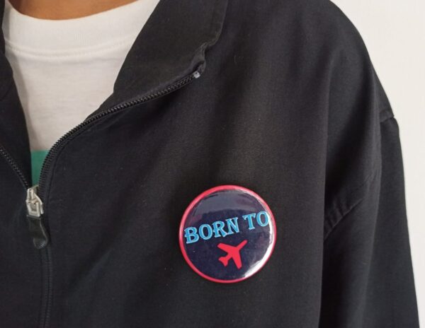 Image of Pin Badge 'Born To Fly' Navy Blue Red on Jacket