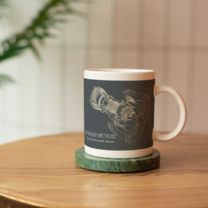 Ceramic mug standing on the green coaster on the round wooden coffee table_In Thrust We Trust Mock Up