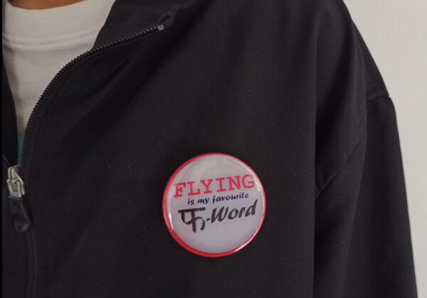 Image of Pin Badge 'Flying is my favourite F-Word Grey on Jacket