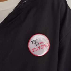 Image of Pin Badge 'Pha Se Flying' Hindi Quote Grey on Jacket